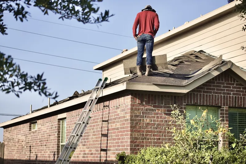 Professional roofer working on a residential roof in Barnstable